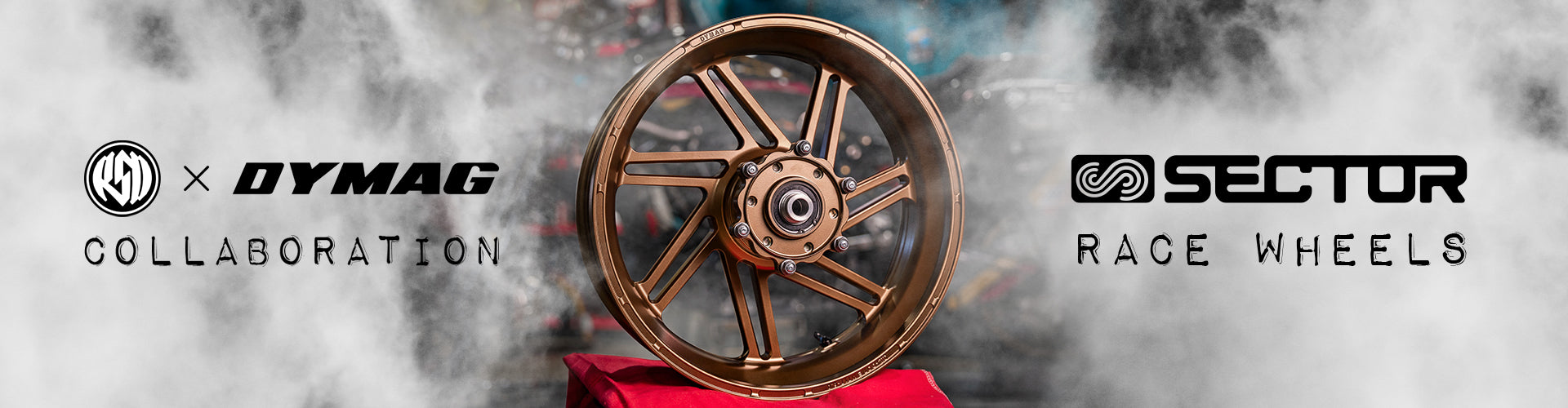 ALT Text: "Promotional banner featuring a collaboration between Dymag and Sector Race Wheels. The image showcases a high-performance racing wheel in bronze, centered on a smoky background with the logos of 'Dymag' and 'Sector Race Wheels' on either side, highlighting the partnership.