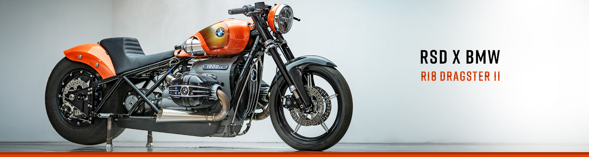 front 3/4 photo of the orange RSD x BMW R18 Dragster II motorcycle.