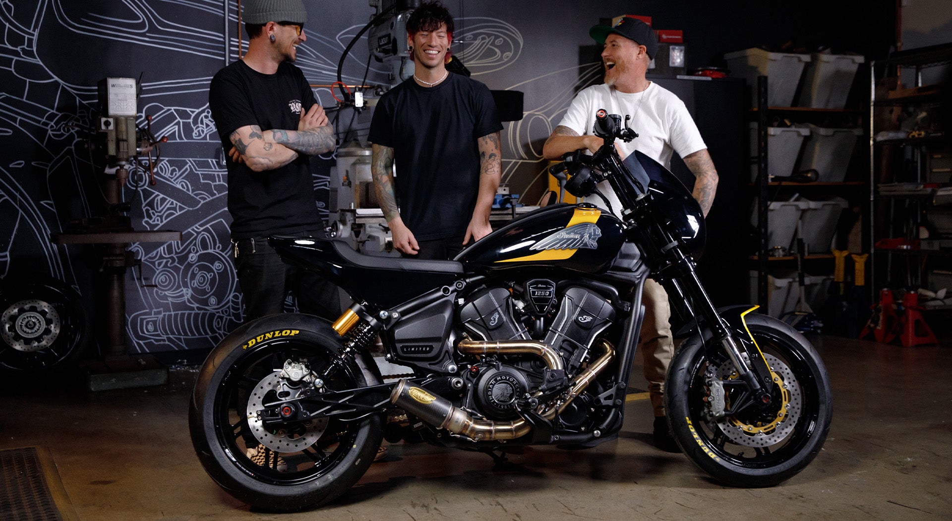 aaron boss, josh dun and roland sands standing behind Josh's new RSD x Indian Bandito Scout motorcycle